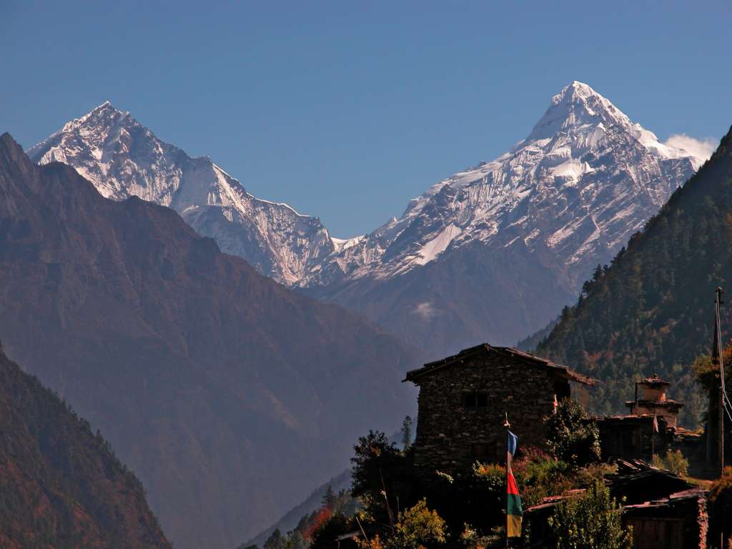 Manaslu 06 05 Ganesh I and Ganesh II From Sho I looked back to the east from Sho (2960m), and saw Ganesh I and II towering above the valley. The name for the range comes from the Hindu deity Ganesha, usually depicted in the form of an elephant. In fact, the south face of Pabil (Ganesh IV) slightly resembles an elephant, with a ridge that is reminiscent of an elephant's trunk. Ganesh I (7422m, also called Yangra) was first climbed via the Southeast Face and Ridge on October 24, 1955 by Raymond Lambert, Eric Gauchat, and famed female climber Claude Kogan. Sadly, Gauchat fell to his death on the descent. Two teams were attempting Ganesh II NW (7118m) at the same time in 1981. The German team was on the North Ridge, while a Japanese team was on the Northeast Spur. The two groups combined at 6300m and finished on the North Face. Reaching the summit on October 16, 1981 were Hermann Warth, Ang Chappal Sherpa, Nga Temba Sherpa, Nima Tenzing Sherpa, Nabuhide Kuwahara, Joji Nakamura, Nobuhiro Hase, Tendi Sherpa, and Kirke Sherpa.